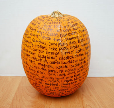 Image contains a pumpkin covered with words written in black permanent marker.