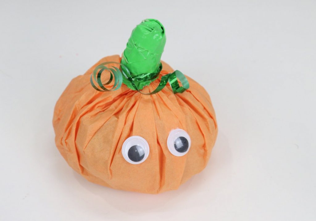 Image contains a pumpkin treat pack with google eyes.