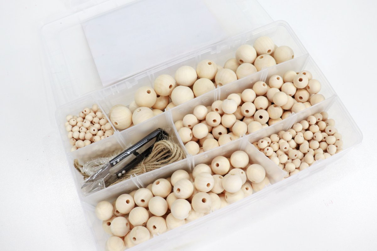 Image contains a box of assorted wooden beads.