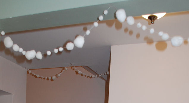 Image contains a decorative snowball garland hanging from the ceiling.