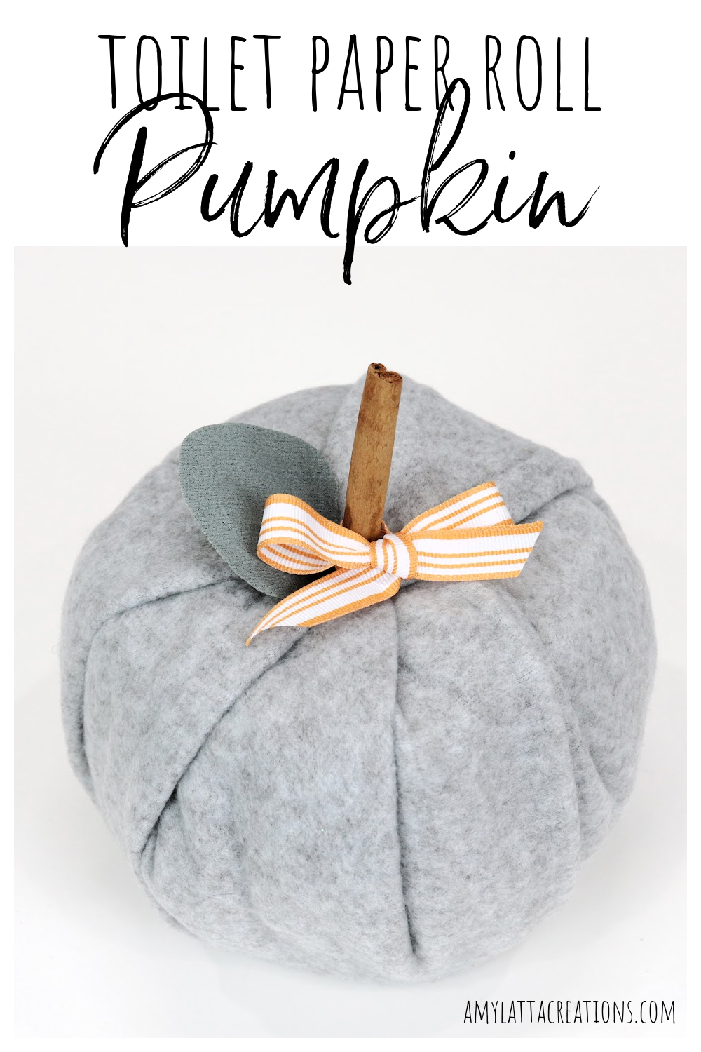Image contains a pumpkin made of a toilet paper roll covered in grey fleece.