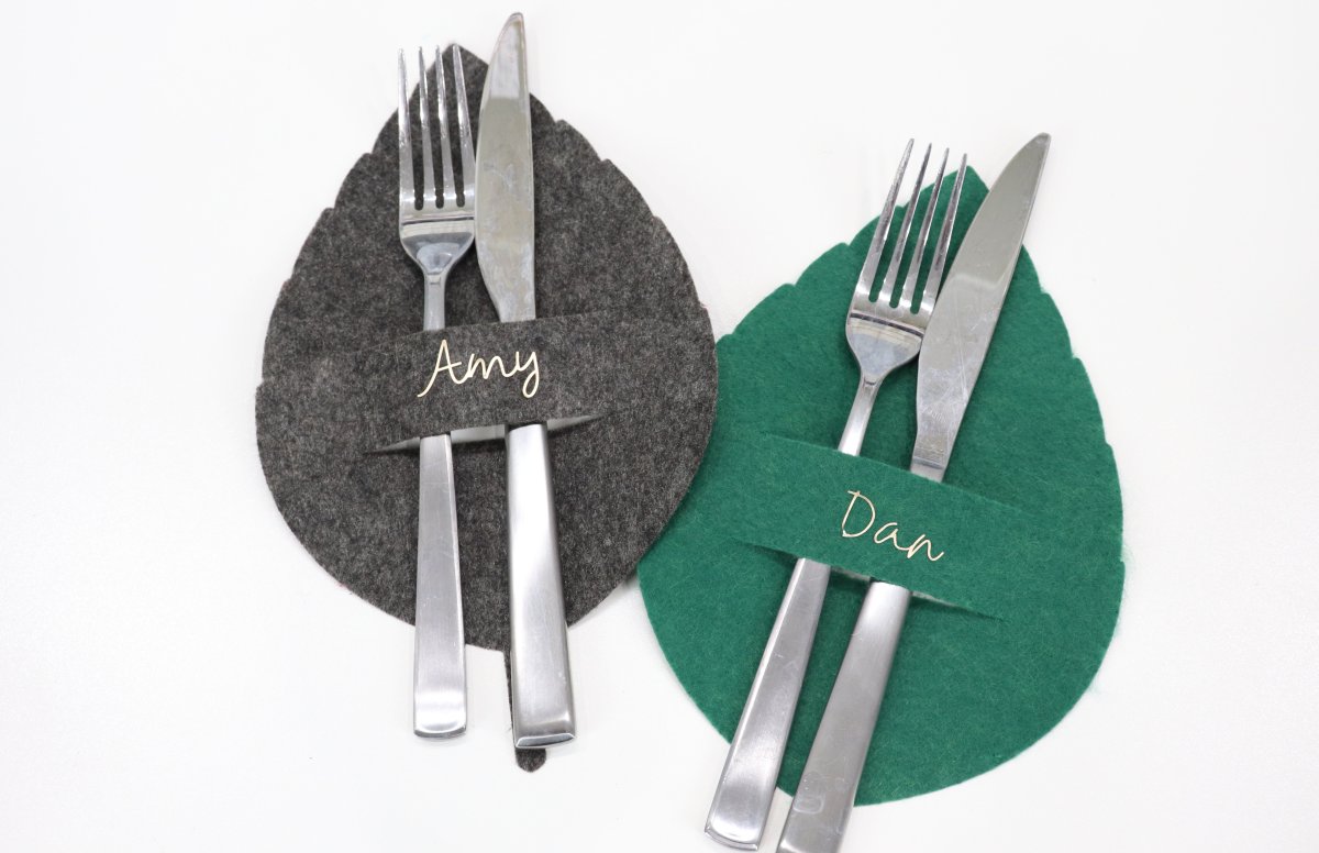 Image contains two felt leaf place settings in grey and green.