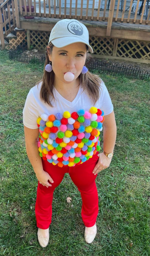 Image contains a woman wearing a gumball machine costume.