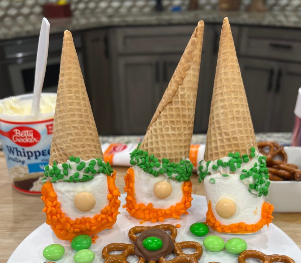 Image contains three Leprechaun Gnomes made from sugar cones, jumbo marshmallows, frosting, and sprinkles.