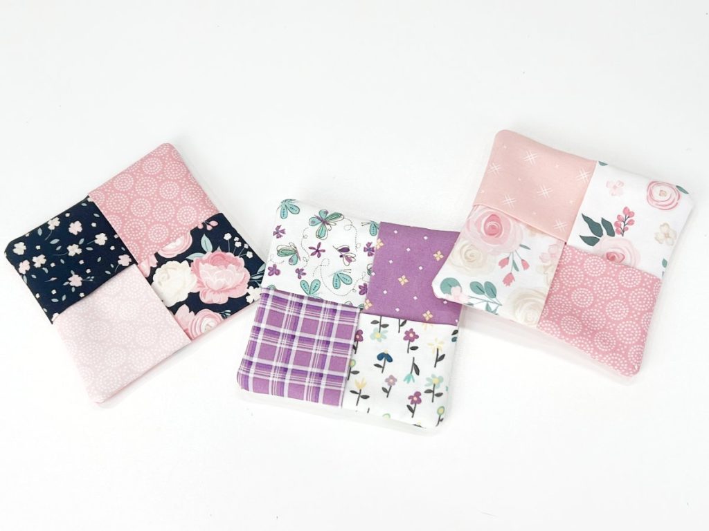 Image contains three square fabric coasters on a white background.