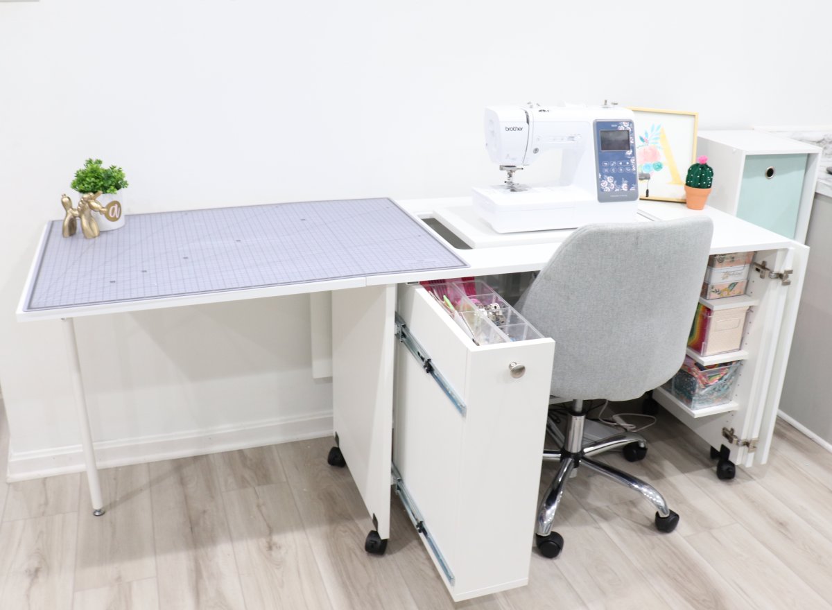 Image contains the Sew Station with the left side table extended and covered with a cutting mat.