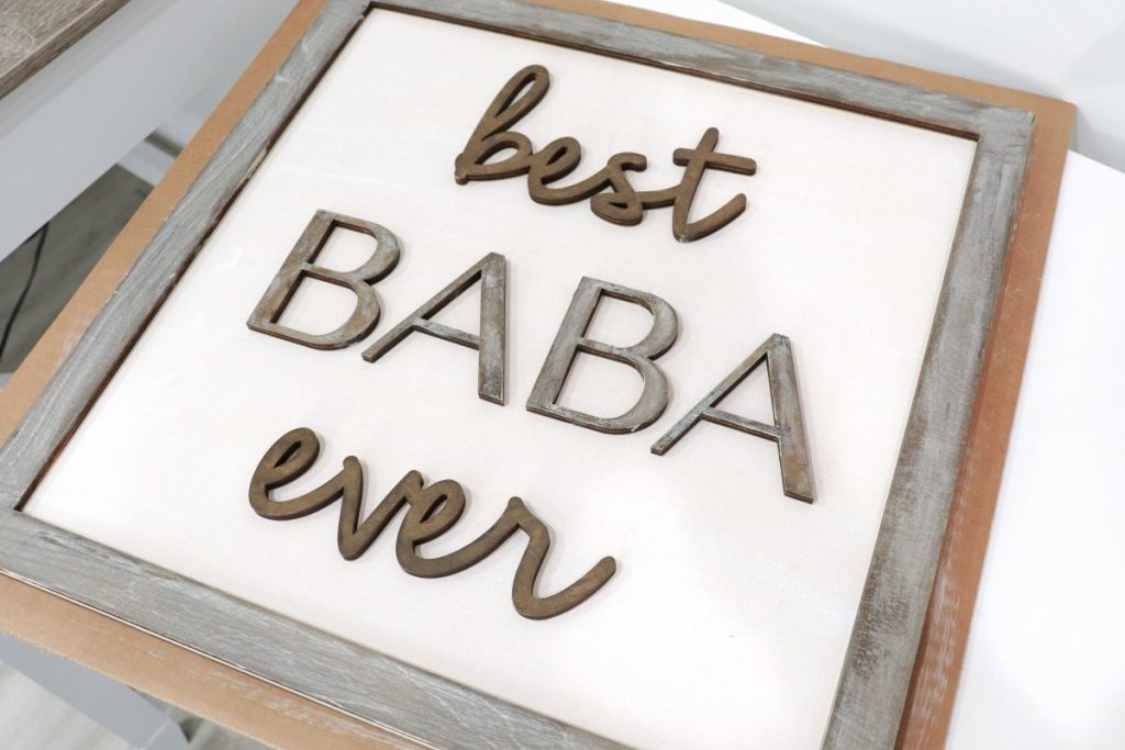 Image contains a wooden sign with the words “best baba ever.'