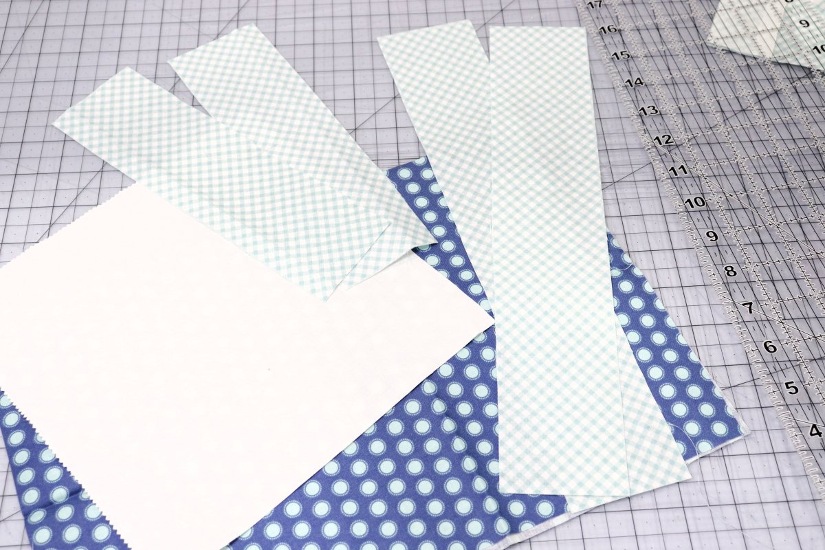 Image contains cut pieces of white and blue print fabrics.