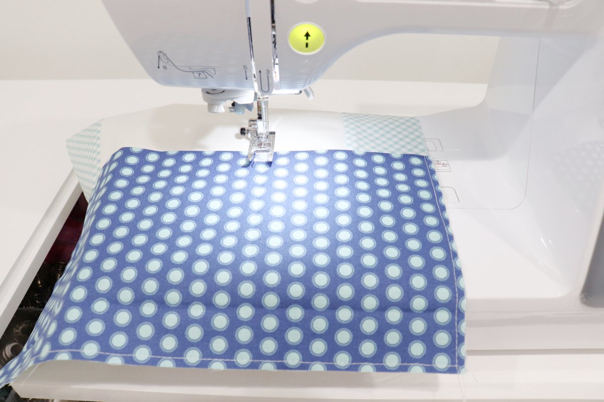 Image shows the pillow front laying on a sewing machine.