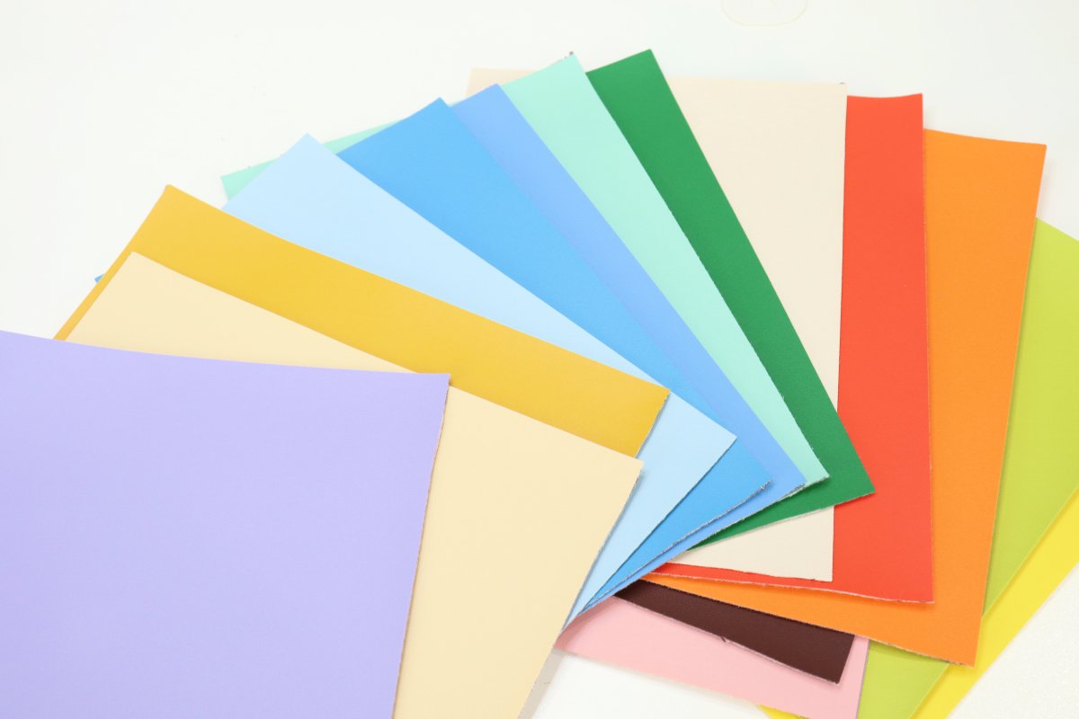 Image contains fifteen sheets of faux leather in an assortment of colors.