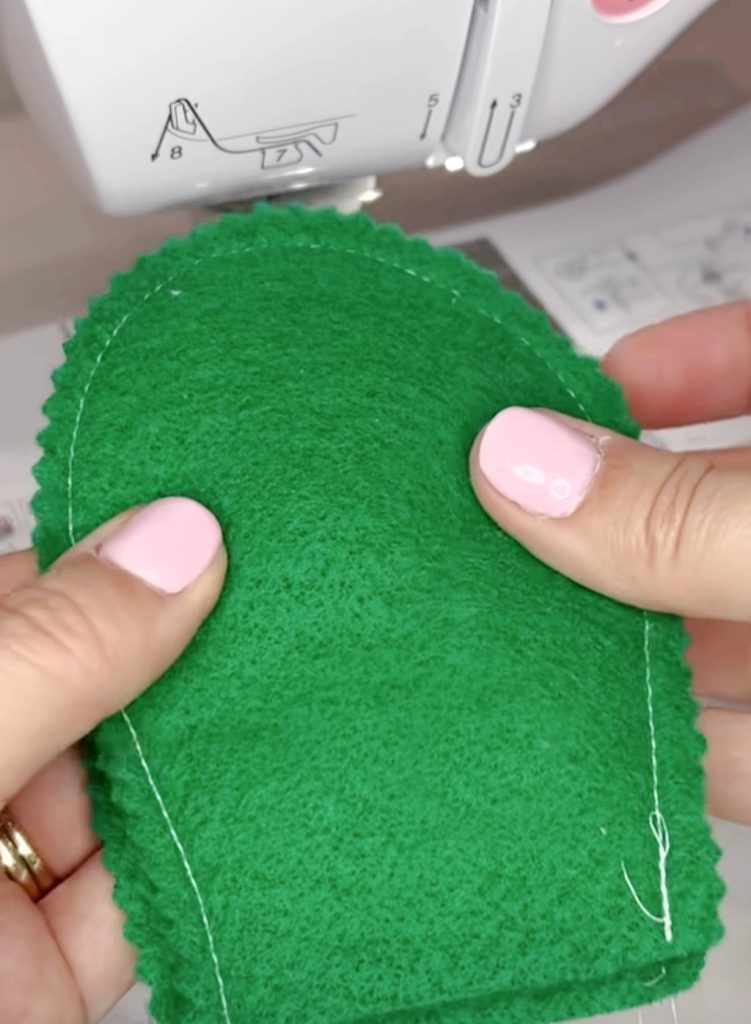 Image contains two green felt pieces sewn together around the outside edges.