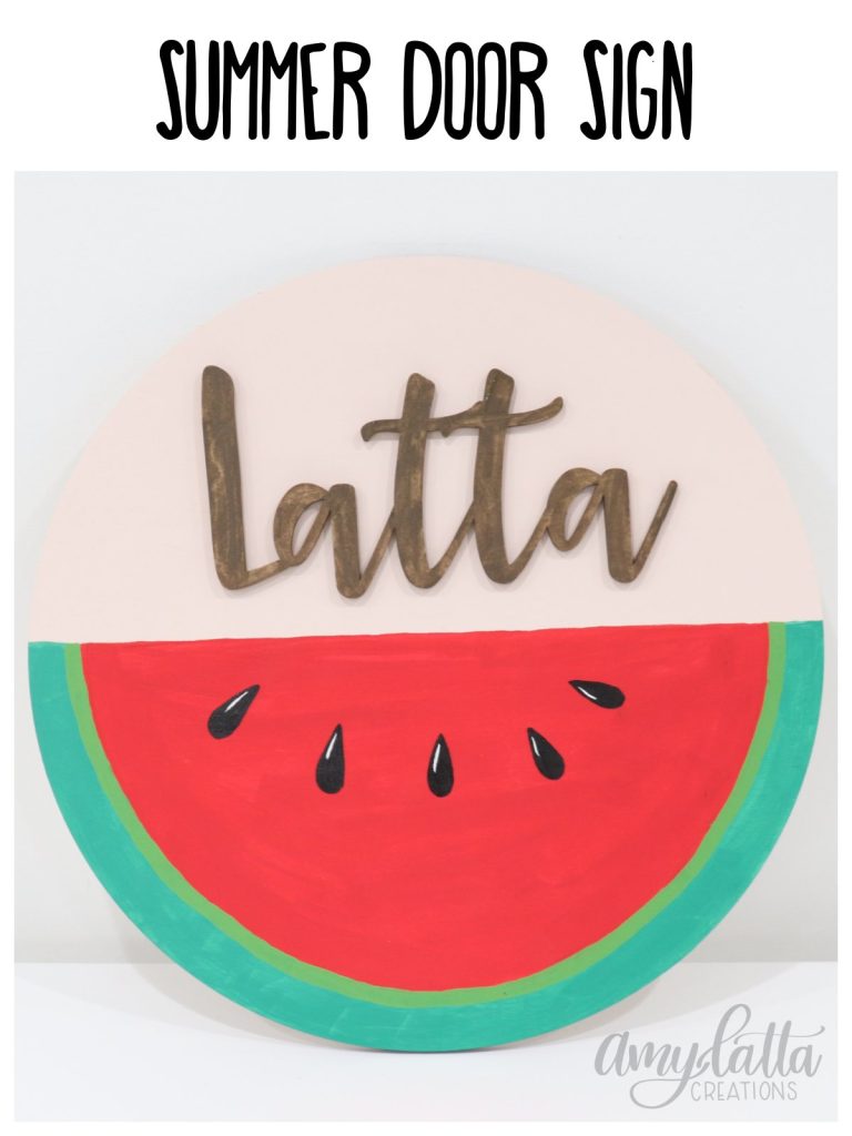 Image contains a large round wooden sign where the bottom half is painted to look like a watermelon, and the top half says the name, Latta.