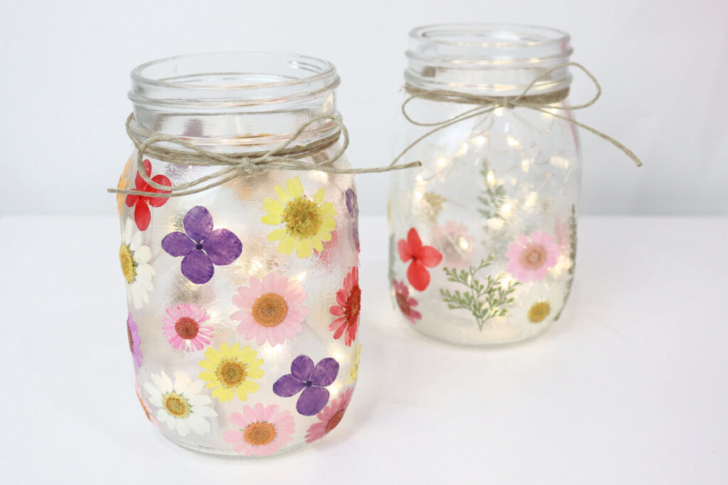 Image contains two pressed flower lanterns on a white background.