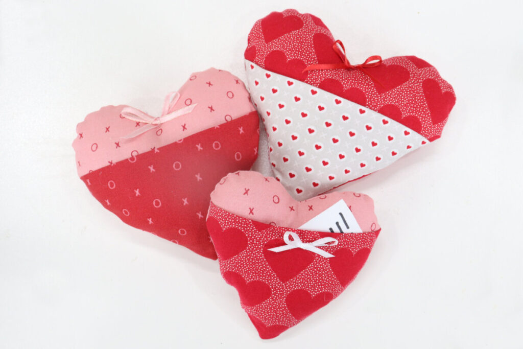 Image contains three plush hearts with pockets, made from valentine fabrics.