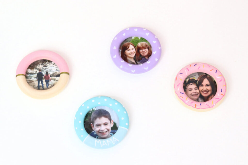 Image contains four round photo magnets made from painted wooden rings on a white background.