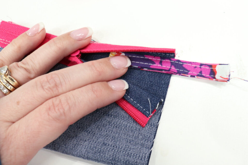 Image contains Amy’s hand holding a fabric loop inside the tube with the folded end facing inward.