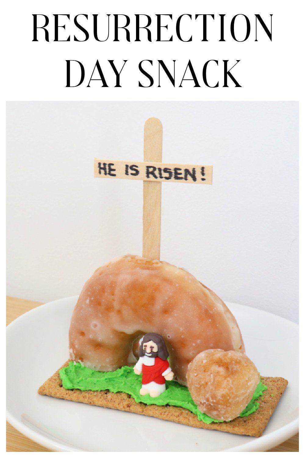 Image contains a resurrection scene made with donuts, frosting, and a graham cracker on a white plate.