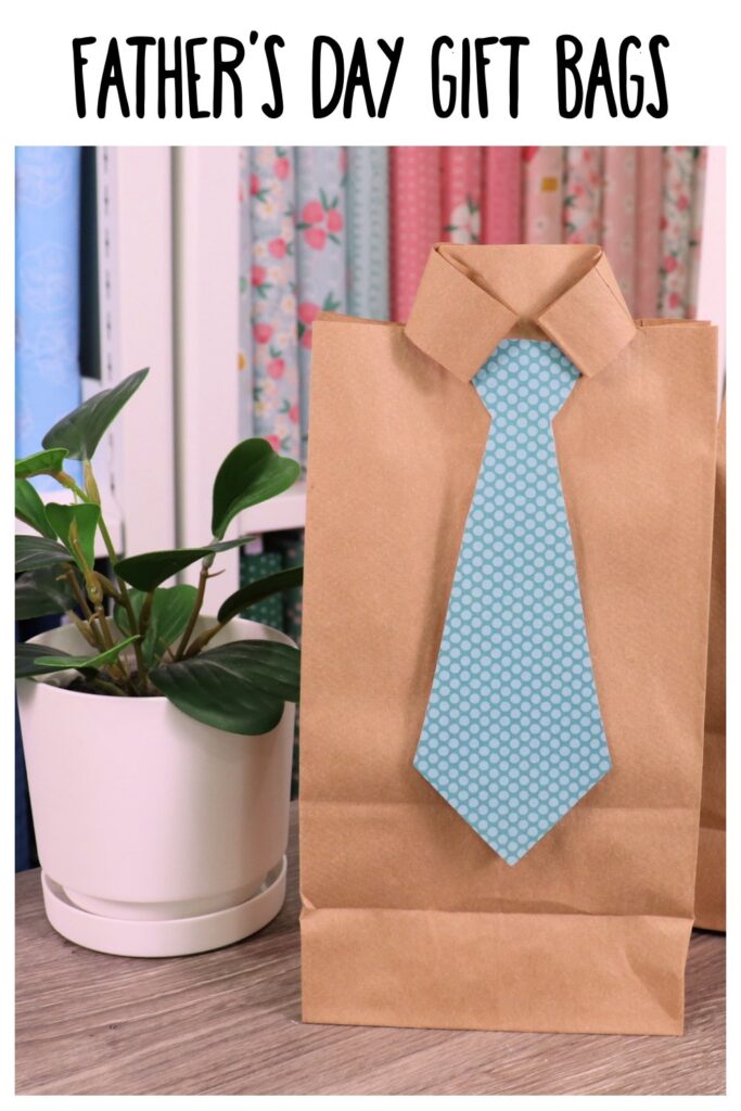 Image contains a paper bag cut and folded to look like a man’s dress shirt with a blue scrapbook paper tie.