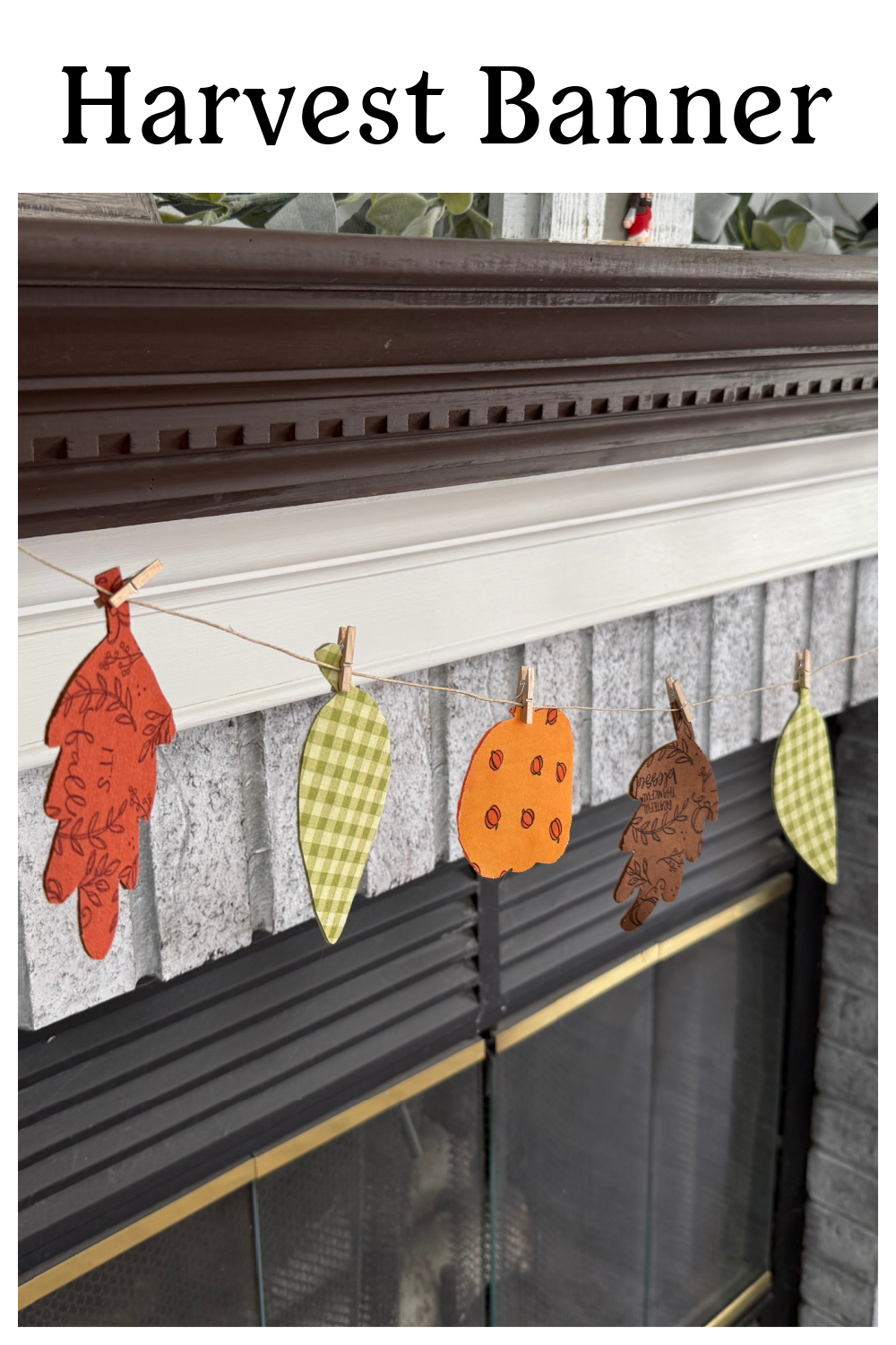 Image contains a harvest banner made from multicolored fabrics and felt.